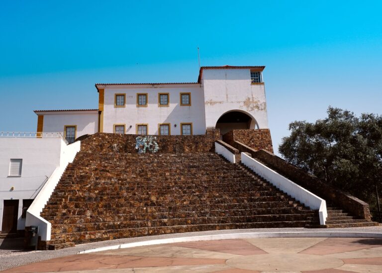 Elevated view of traditional Portuguese architecture in Odemira, Portugal under a clear blue sky.