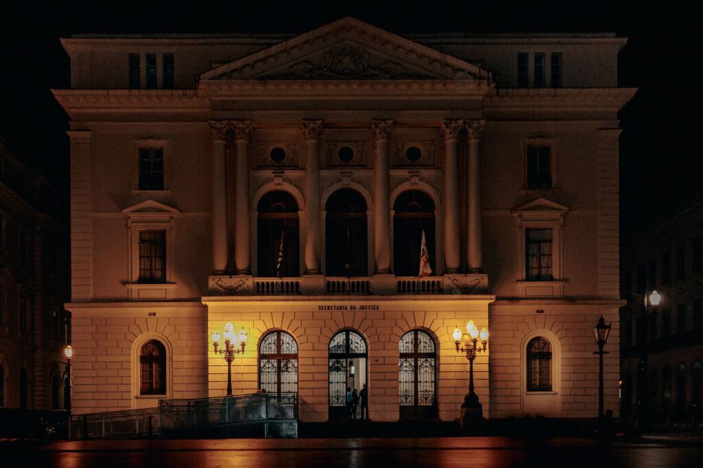 Elegant neoclassical facade illuminated at night in São Paulo's city center. Architectural details stand out.